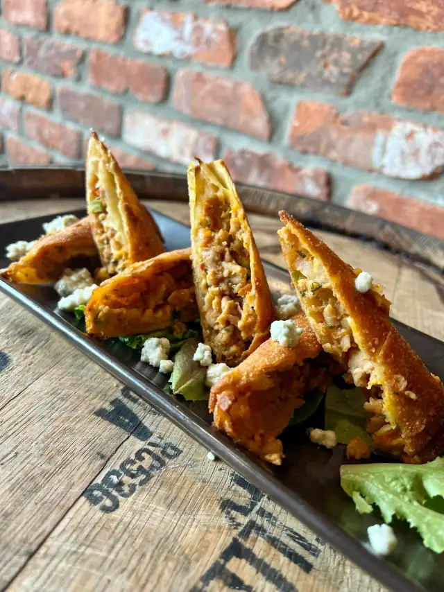 Fried appetizers on a whiskey barrel head