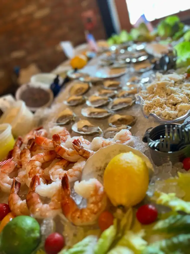 Raw bar tray of oysters and shrimp with lemon