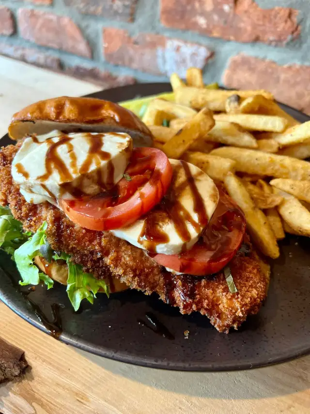 Crispy chicken sandwich with tomato and fries